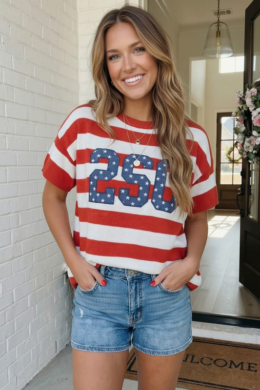 Woman wearing a red, white, and blue striped shirt with '250' on it, standing outdoors.