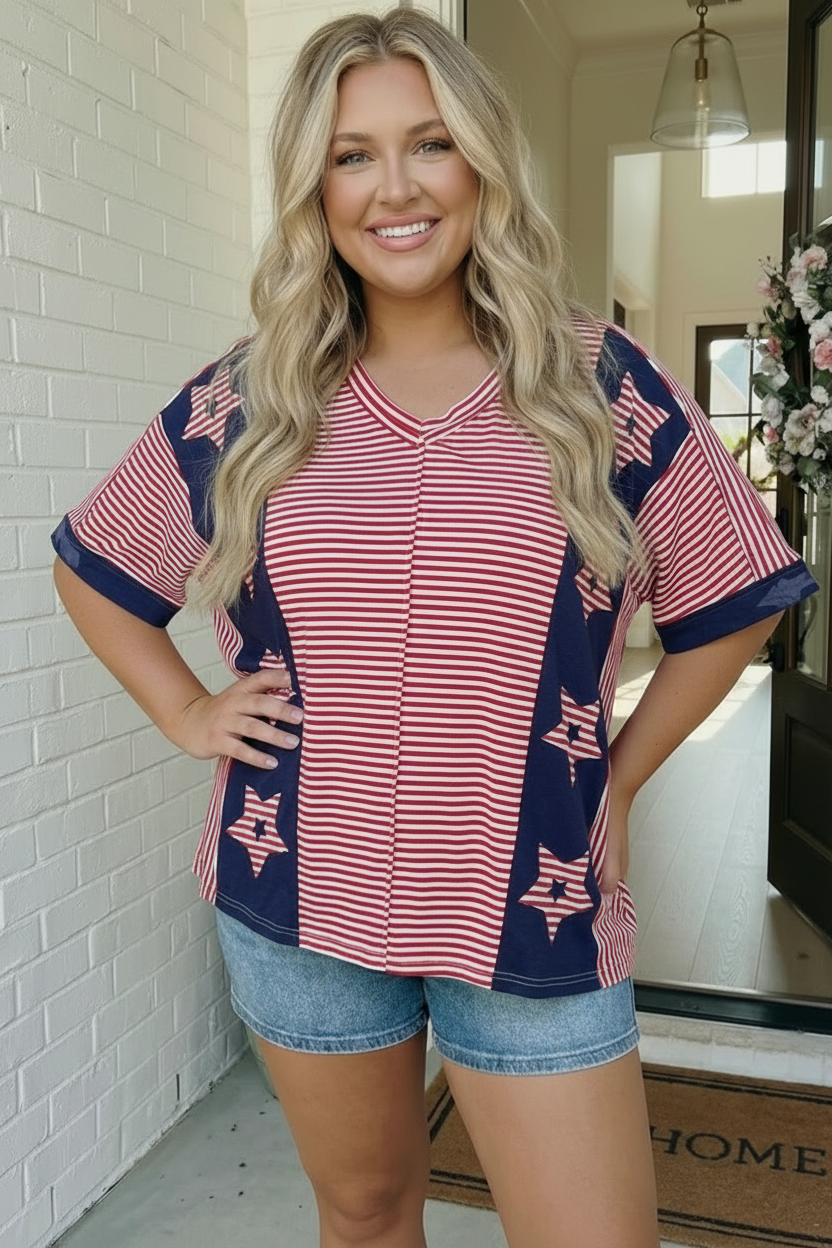 Woman wearing a red, white, and blue striped top with star patterns in a home setting.