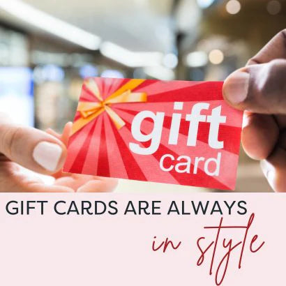 A hand holding a red and white gift card with 'GIFT CARD' text and a decorative bow graphic.