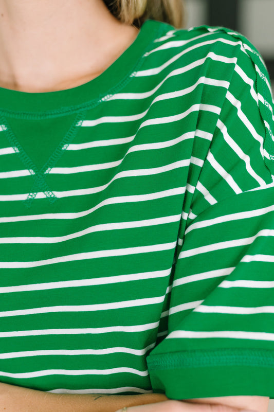 Green and white striped shirt worn by a person