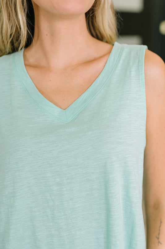 Light blue sleeveless top worn by a person with blurred background