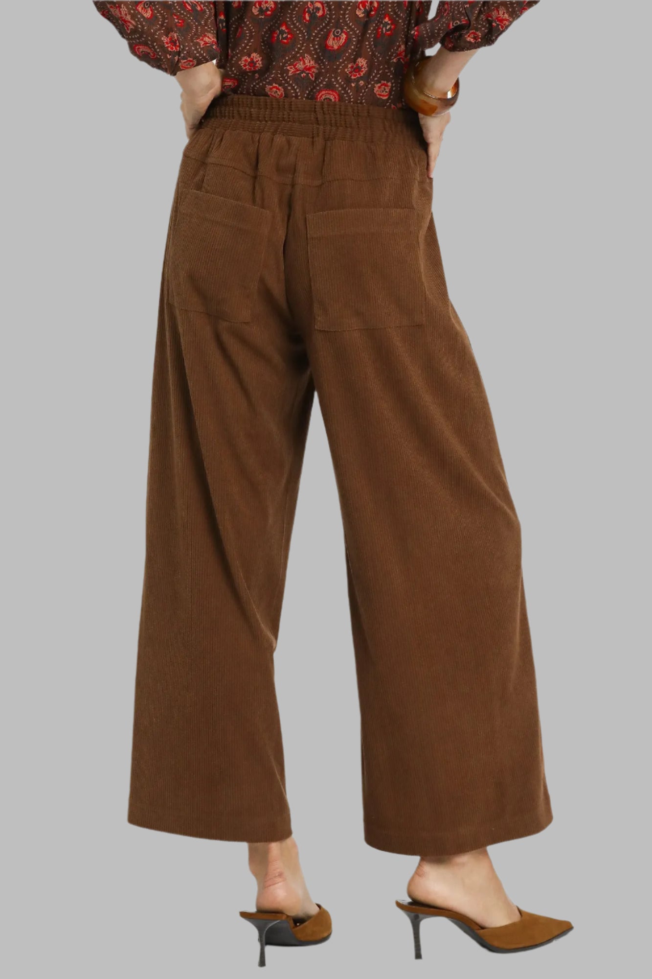 Brown wide-leg pants worn by a person on a white background
