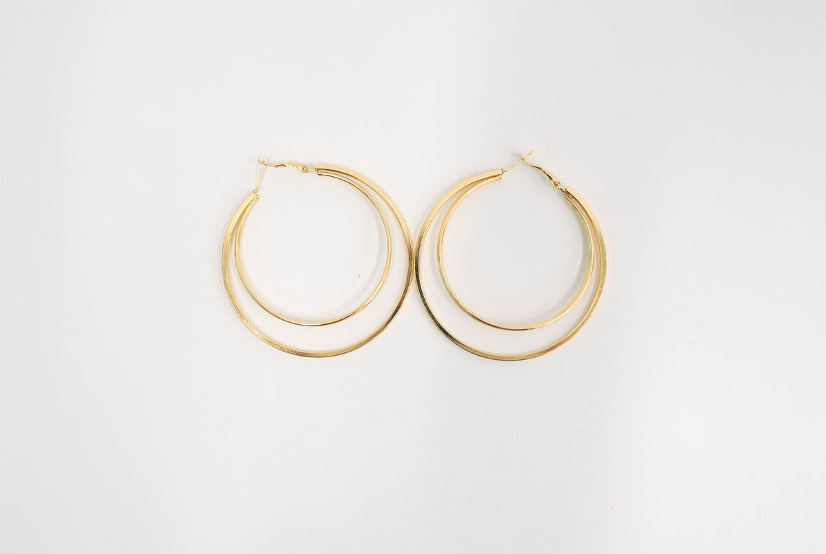 A pair of gold-toned double-hoop earrings on a clean white background.