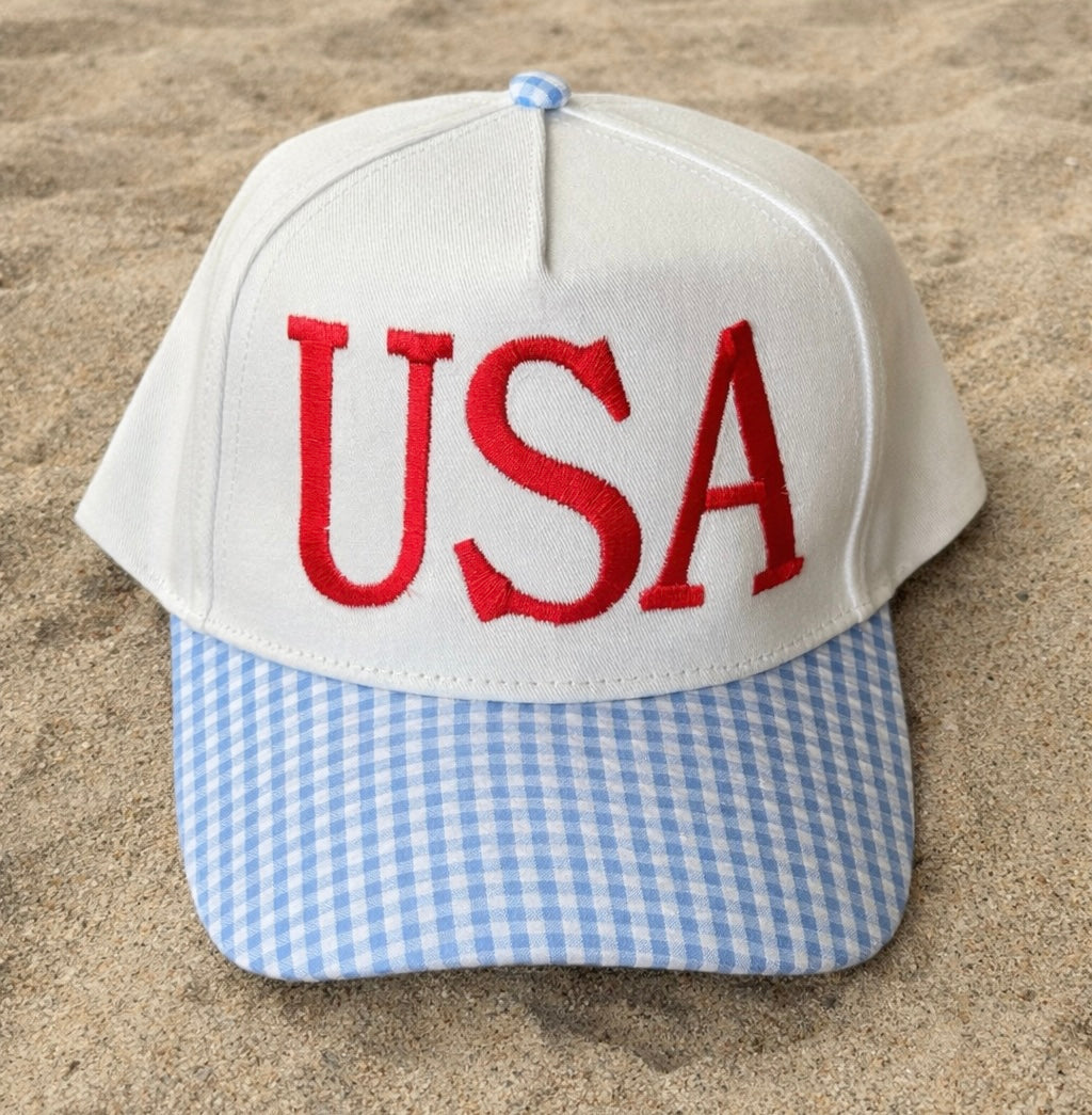 Cap with 'USA' on a sandy background