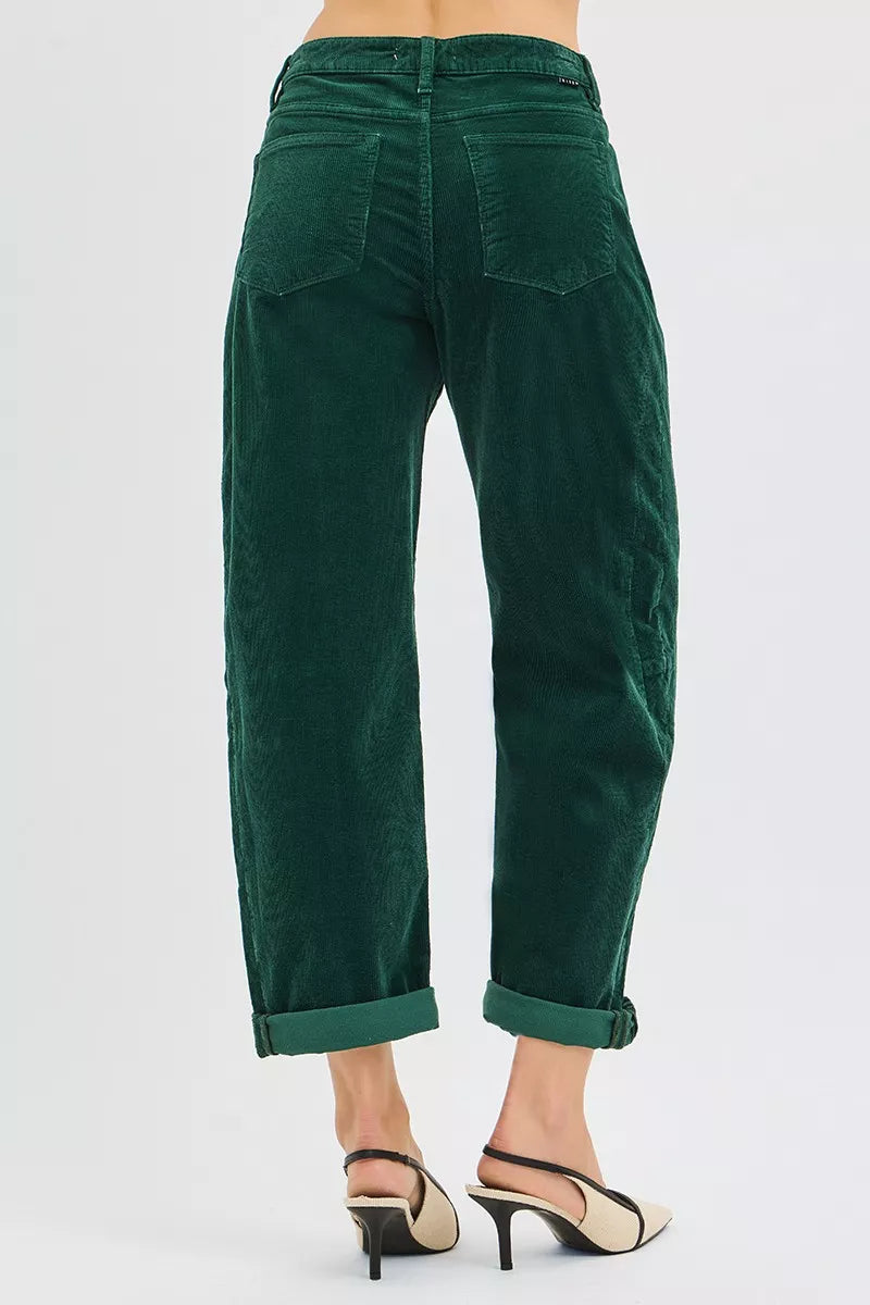 Green corduroy pants by risen worn by a person on a white background