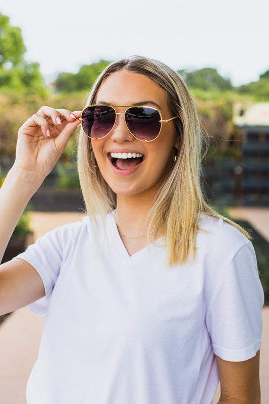 women wearing aviator purple lens gold rimmed sunglasses