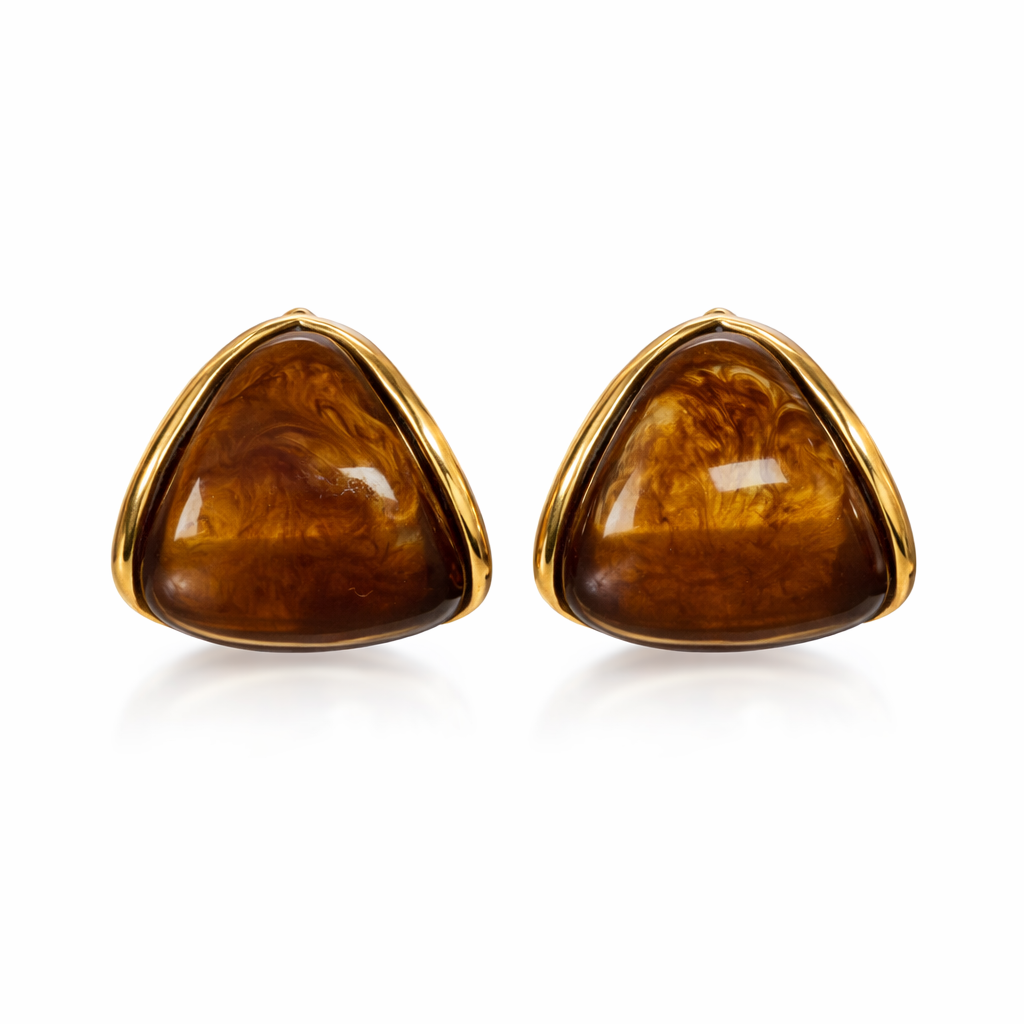 Pair of gold-trimmed triangular amber earrings on a white background