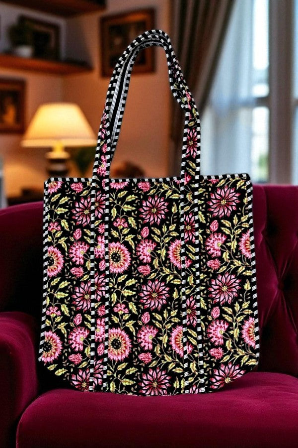 Floral-patterned tote bag on a red chair with a blurred indoor background