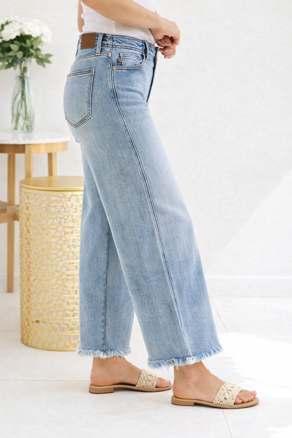 Light blue jeans worn by a person on a white background