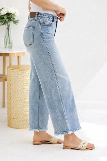 Light blue jeans worn by a person on a white background