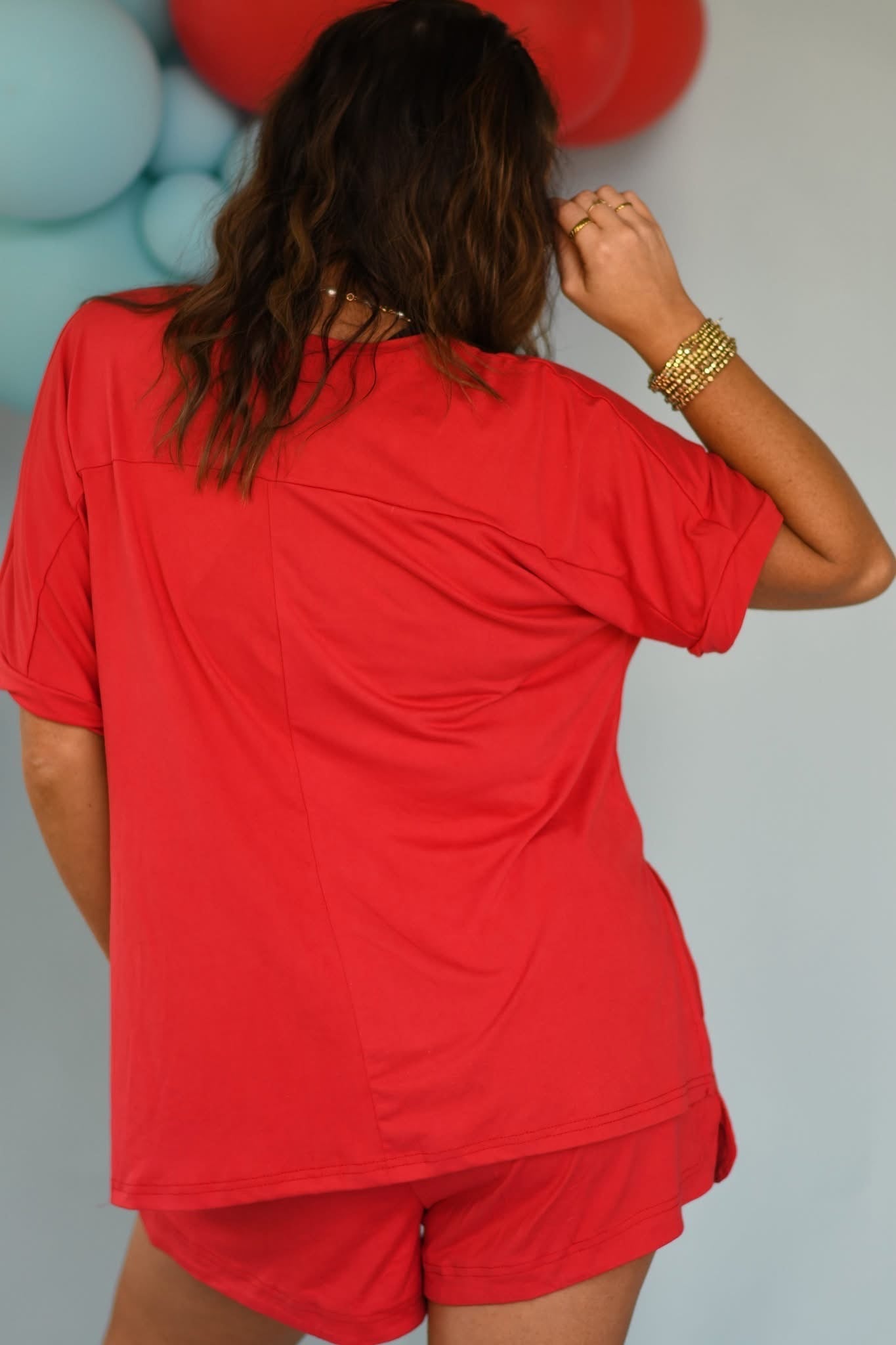 Person wearing a red outfit with a plain background