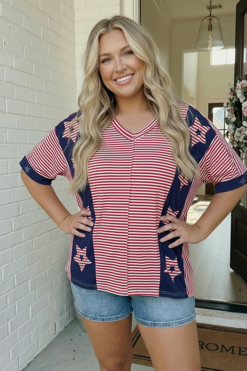 Woman wearing a red, white, and blue top with star patterns indoors.