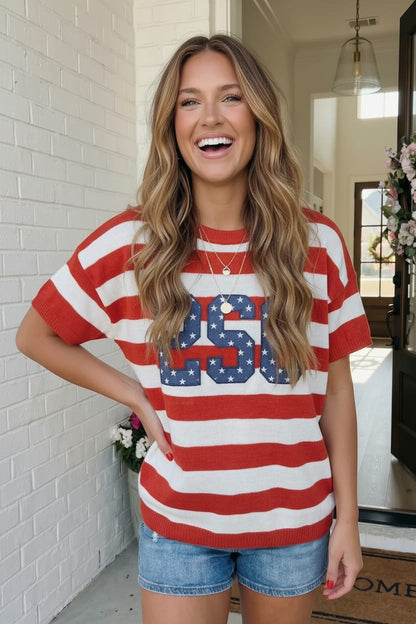 Woman wearing a red, white, and blue striped shirt with '250' printed on it, standing outside.
