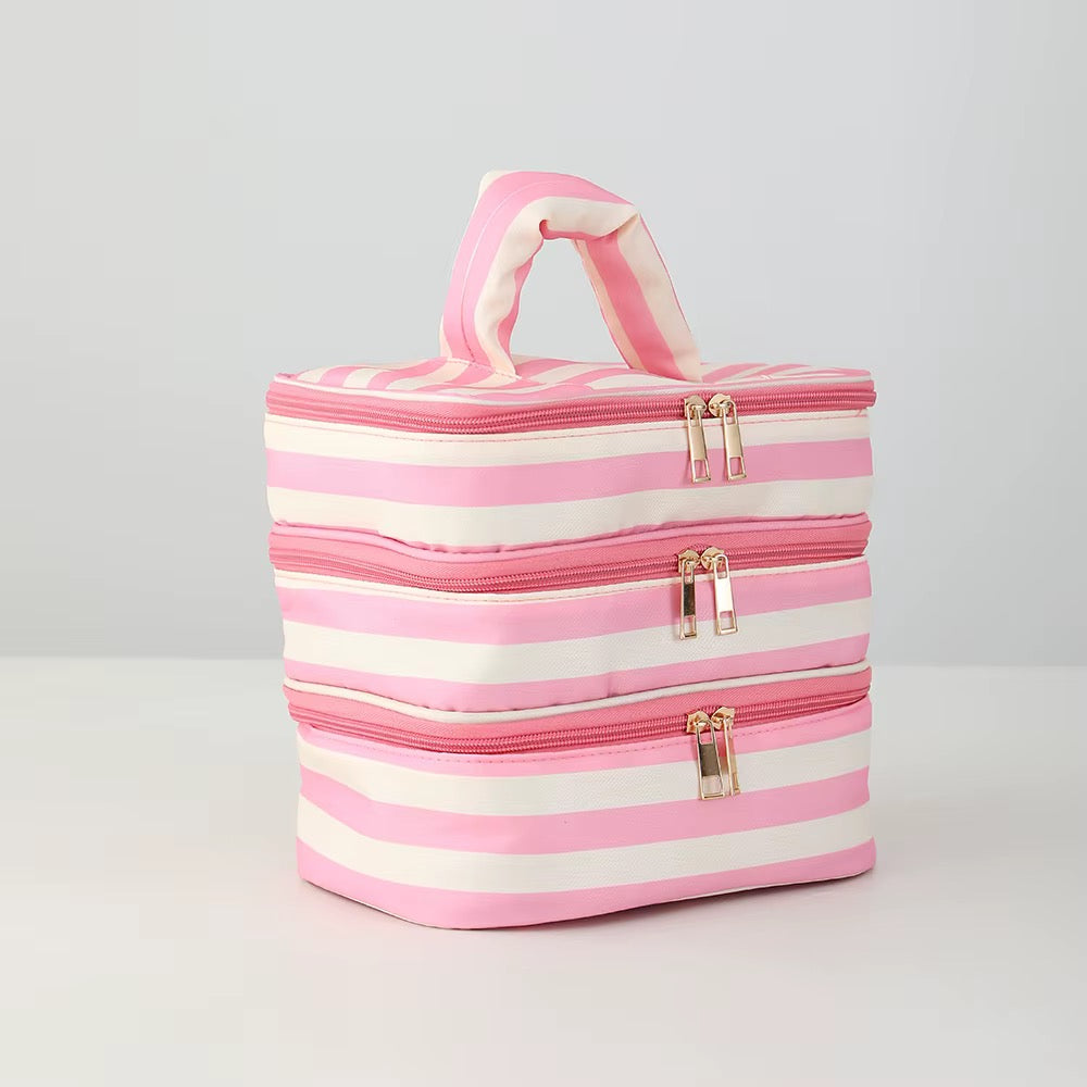 pink and cream make up bag with three zipper compartments 