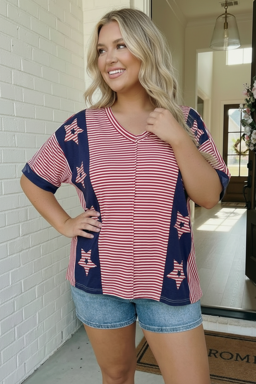 Woman wearing a red, white, and blue top with star patterns indoors.