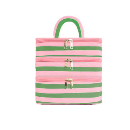 A pink and green striped mini tote bag with three horizontal zippered compartments and a top handle, shown against a plain white background.