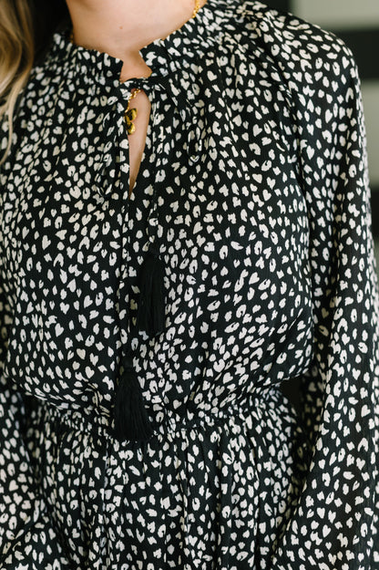 Black blouse with white pattern worn by a person