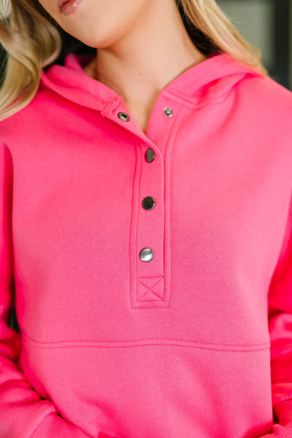 Close-up of a pink hoodie with button details