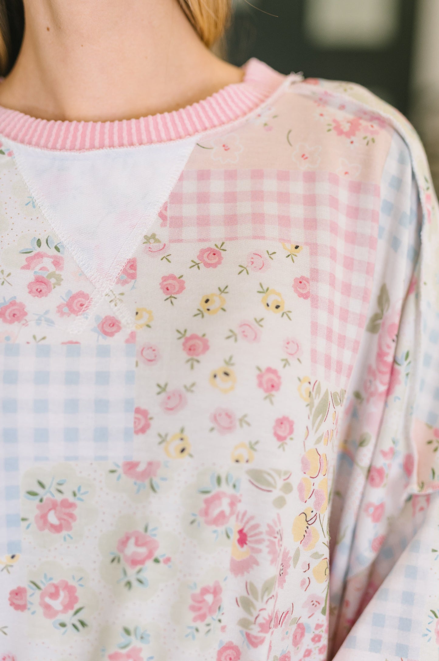 Close-up of a floral-patterned garment with a checkered design.