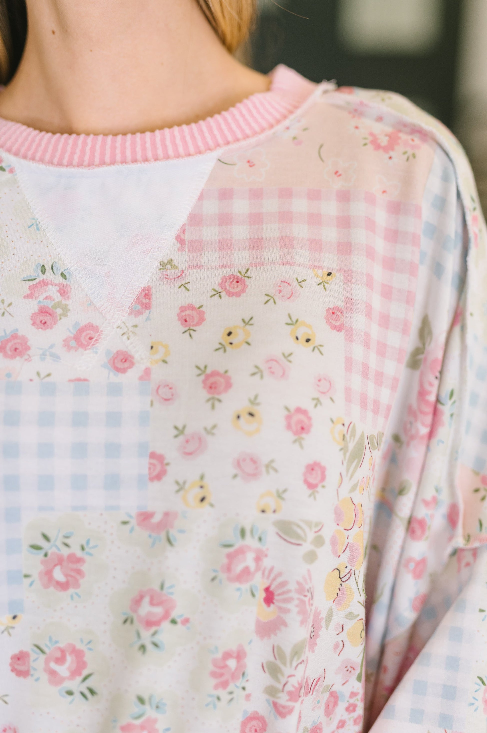 Close-up of a floral-patterned garment with a checkered design.