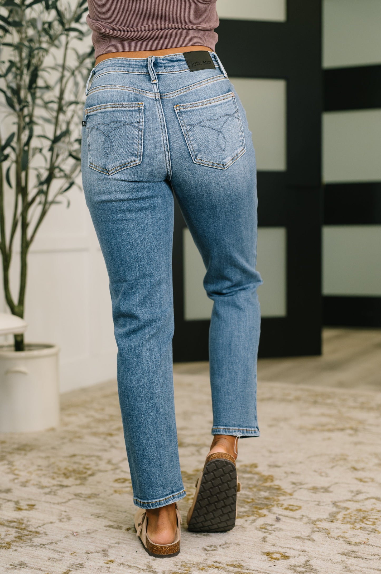 Person wearing blue jeans with a blurred background