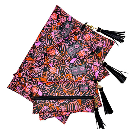 Colorful Halloween-themed bag with tassels on a white background