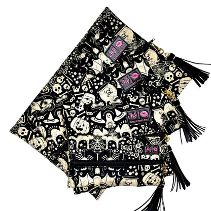 Black and white patterned bag with tassels on a white background
