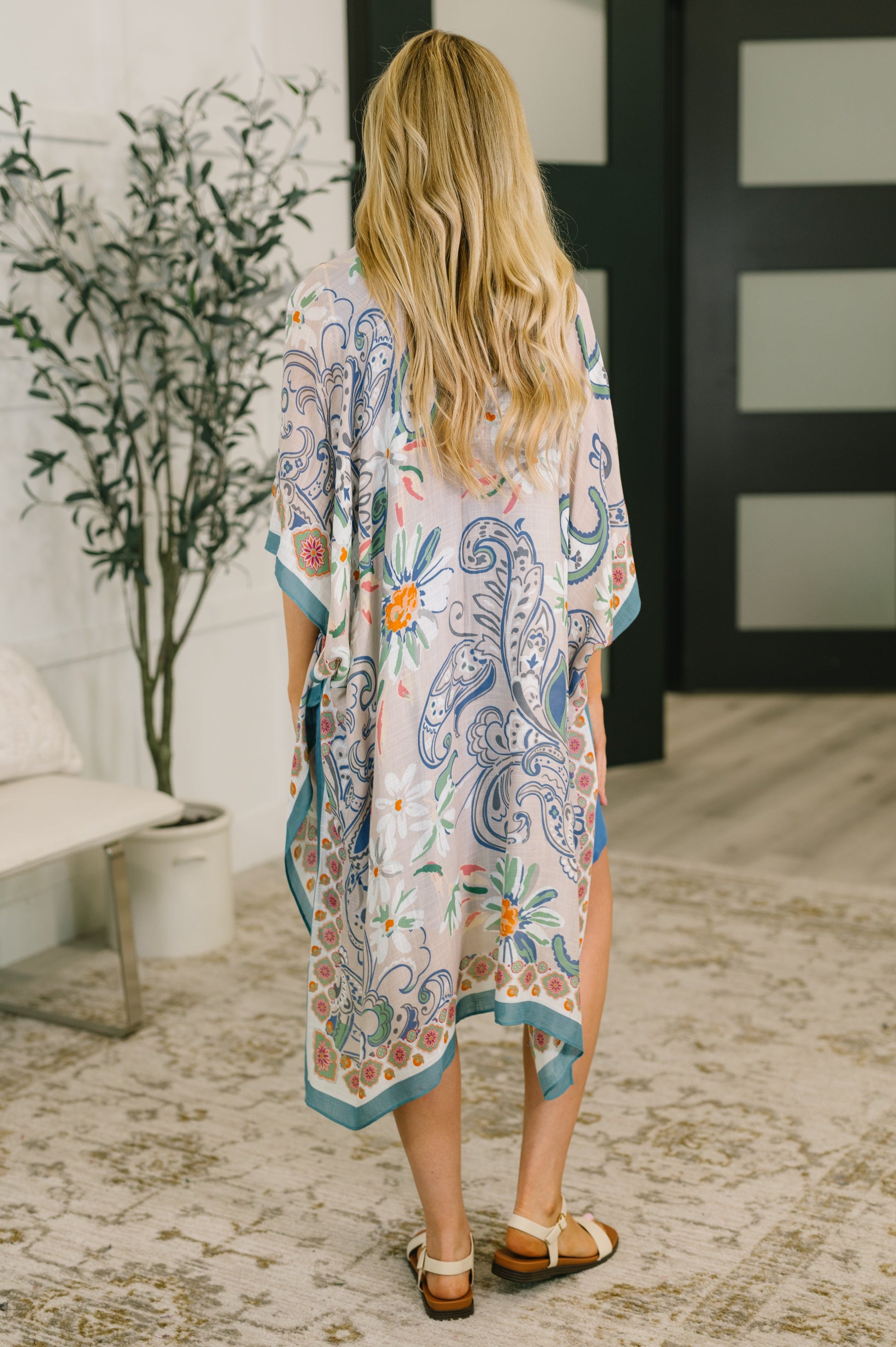 Woman wearing a floral kimono in an indoor setting