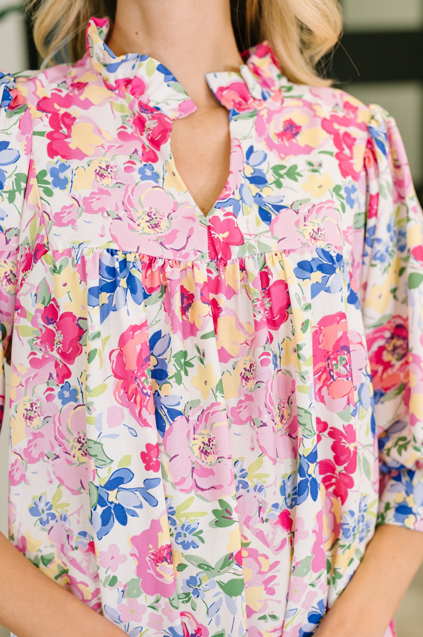 Colorful floral blouse worn by a person