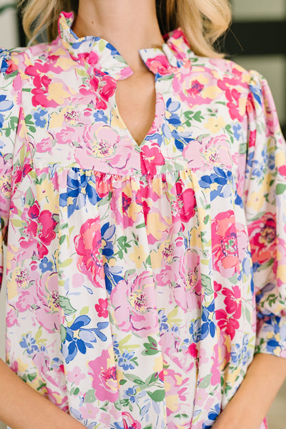 Colorful floral blouse worn by a person