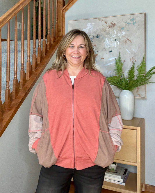 Woman standing in a colorblock dolman sleeve full zip 