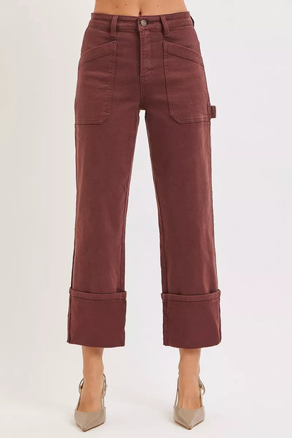 Burgundy Jeans worn by a person on a white background