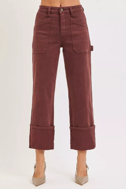 Burgundy Jeans worn by a person on a white background
