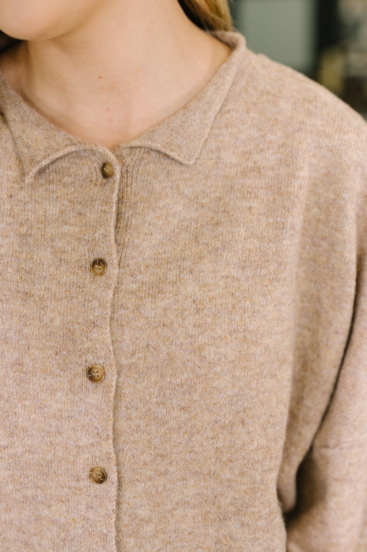 close up of brown button up cardigan