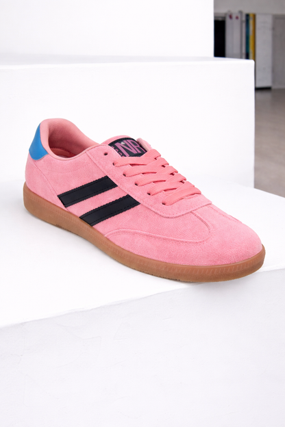 Pink sneaker with black stripes and blue accents on a white surface