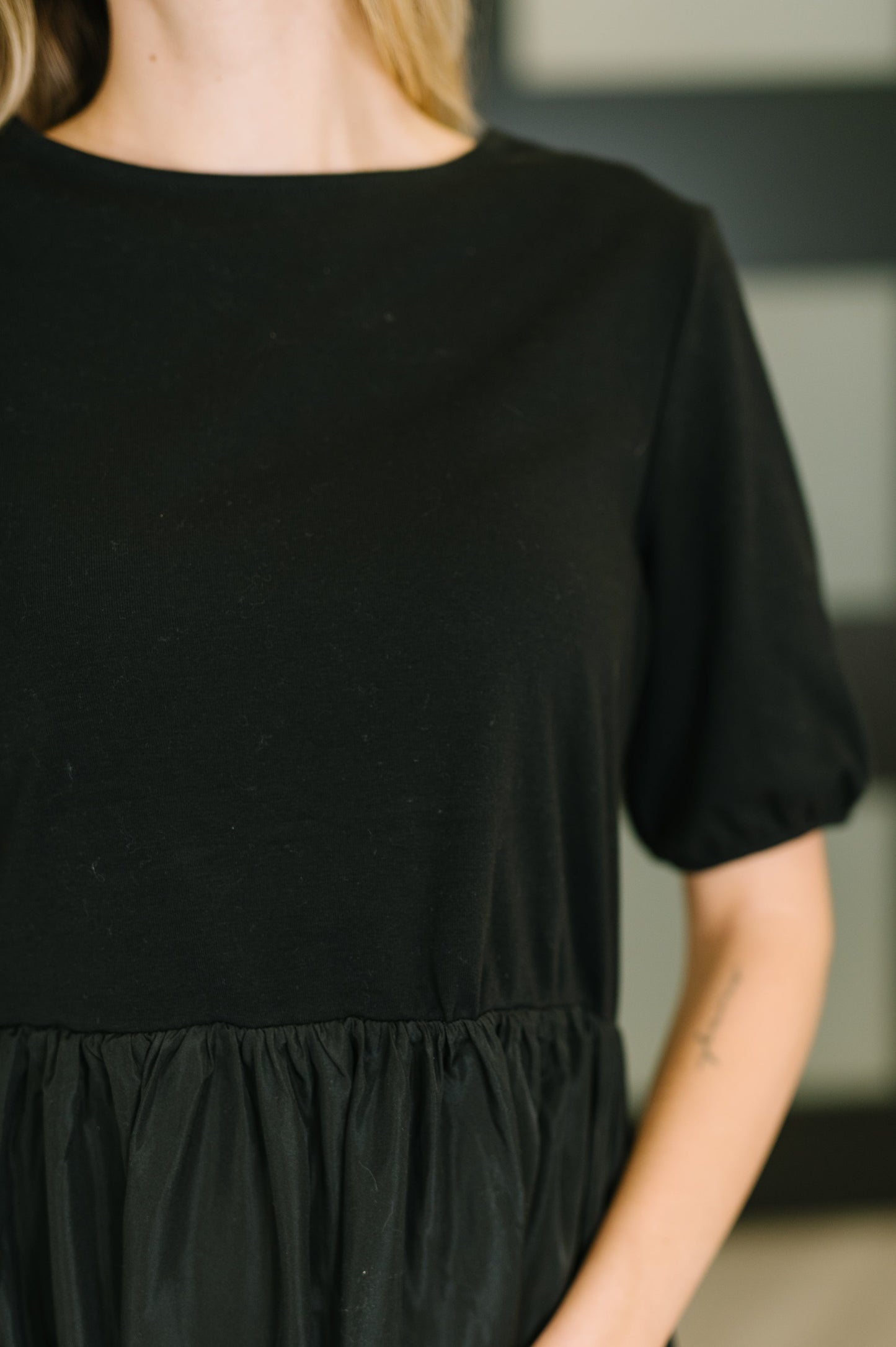 Black dress worn by a person with a blurred background