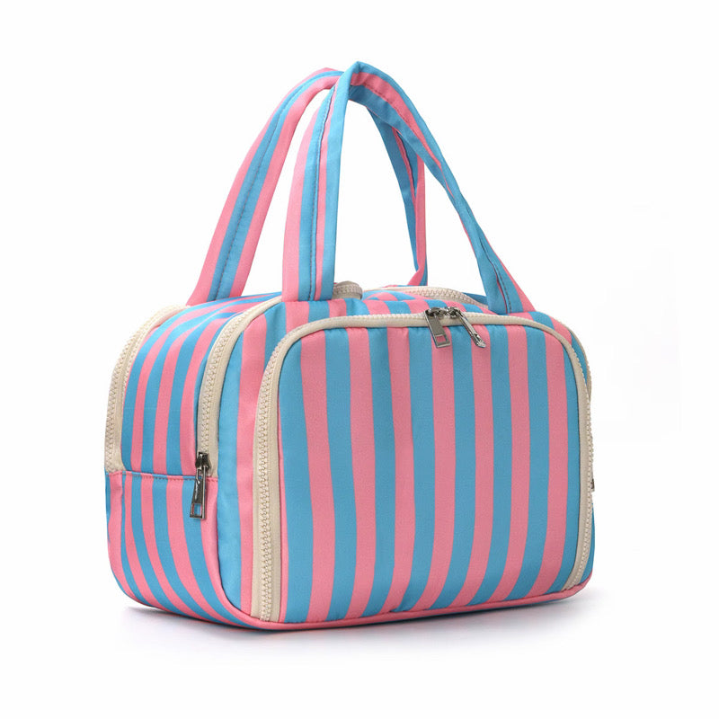 Striped handbag with pink and blue stripes on a white background