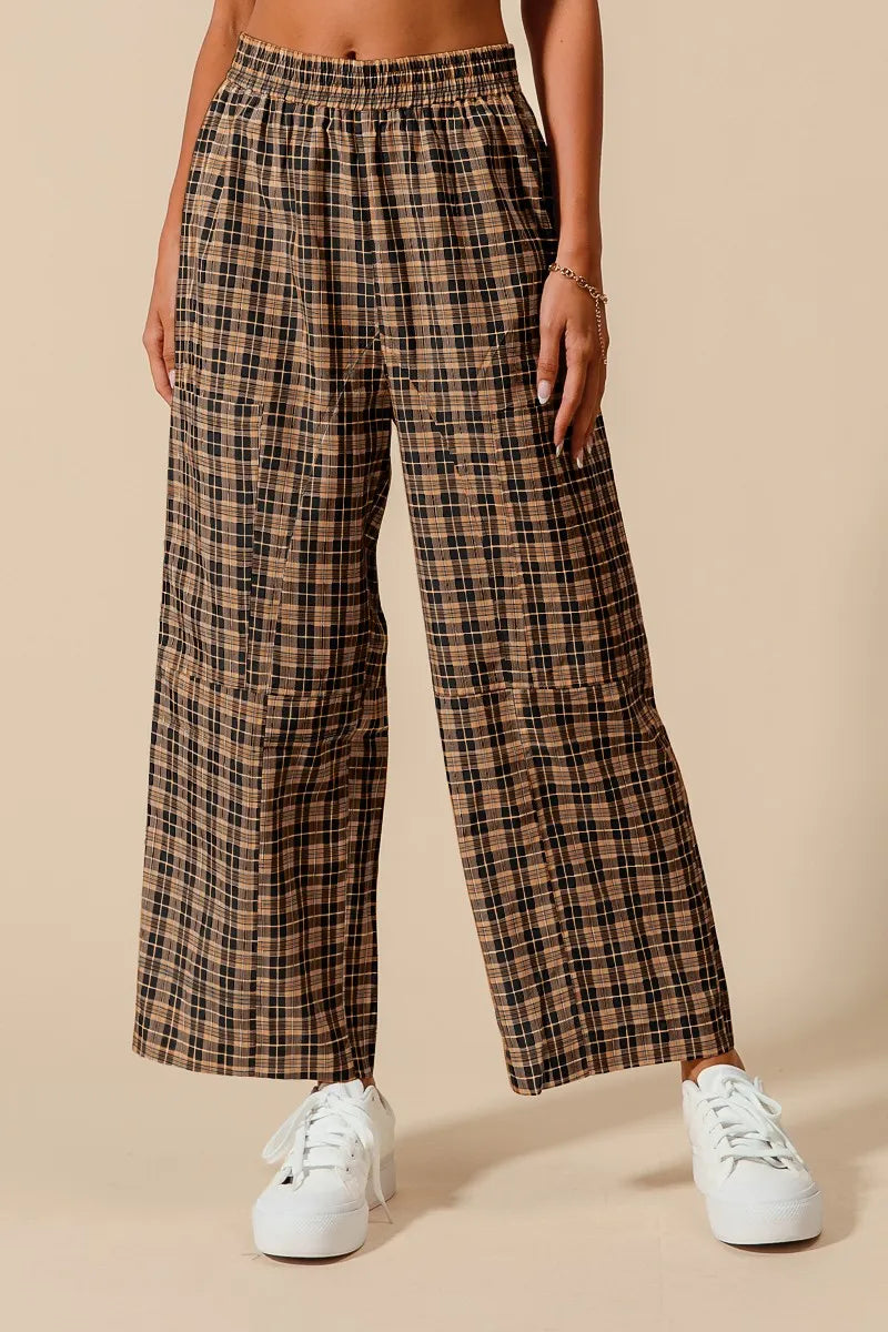Plaid pants worn by a person on a beige background