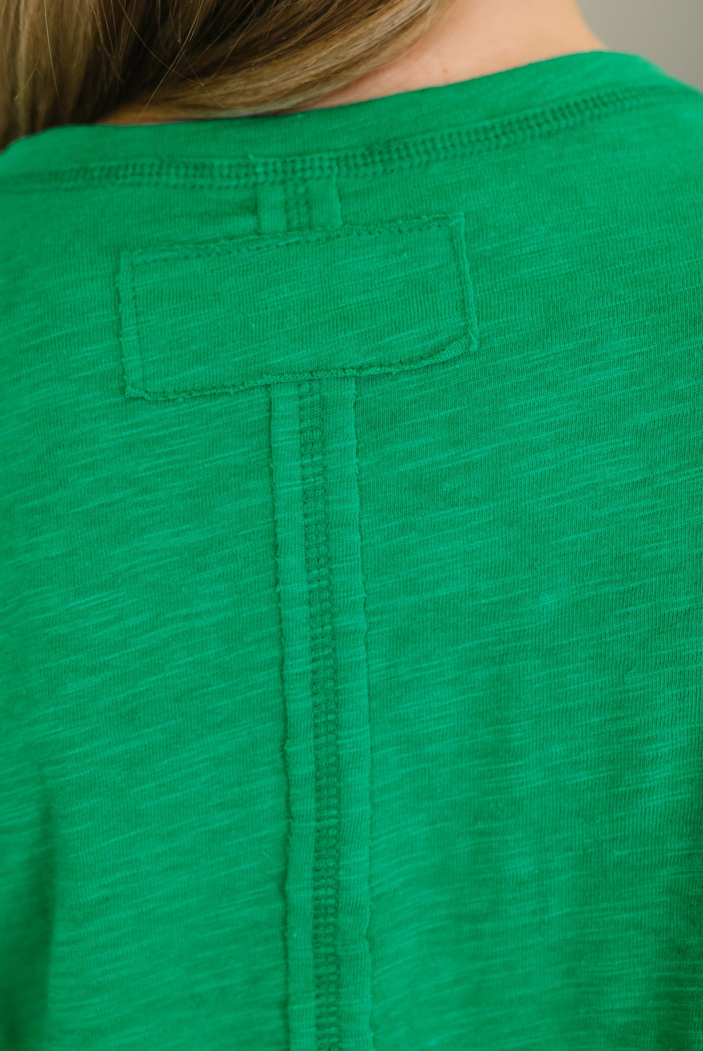 Green shirt with a pocket on a plain background
