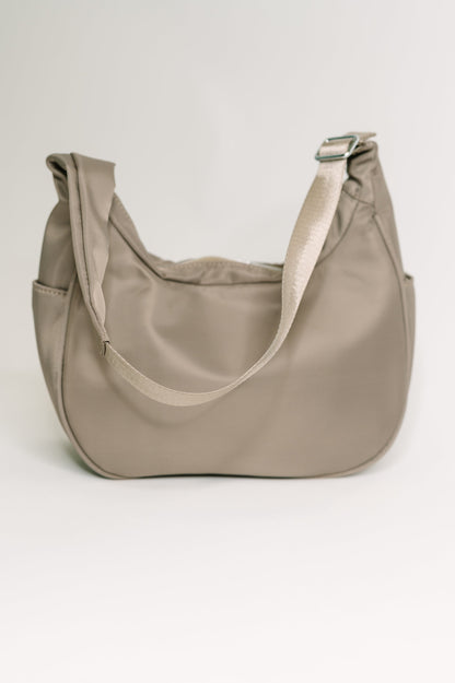 Beige handbag on a light gray background