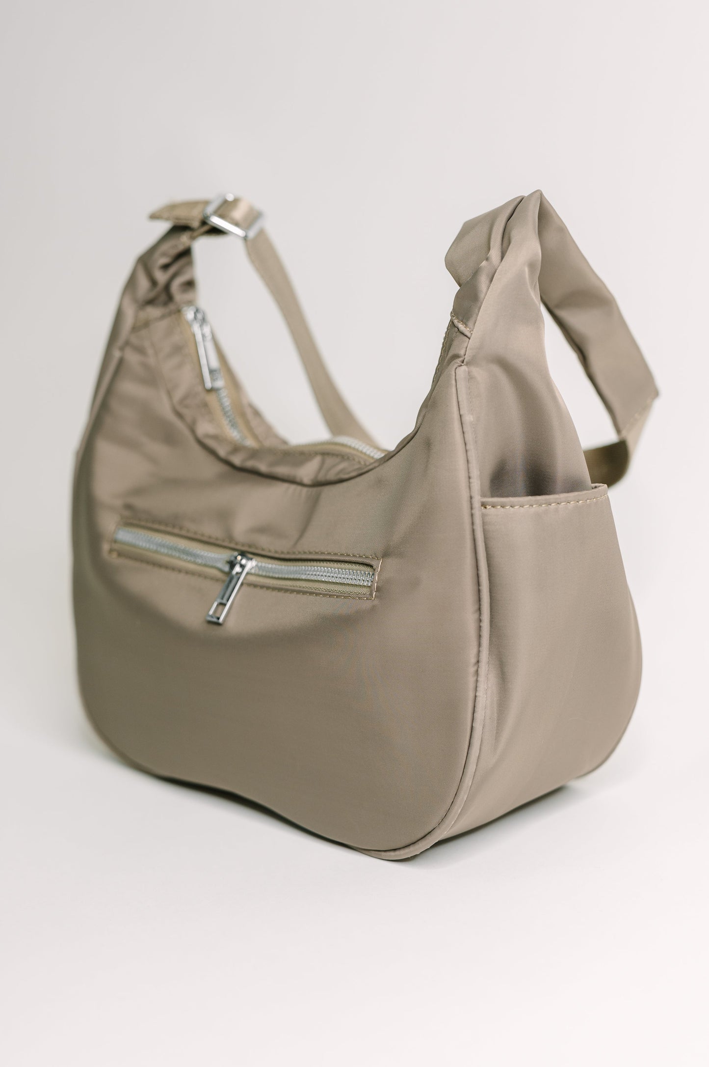 Beige handbag with a zipper on a light gray background