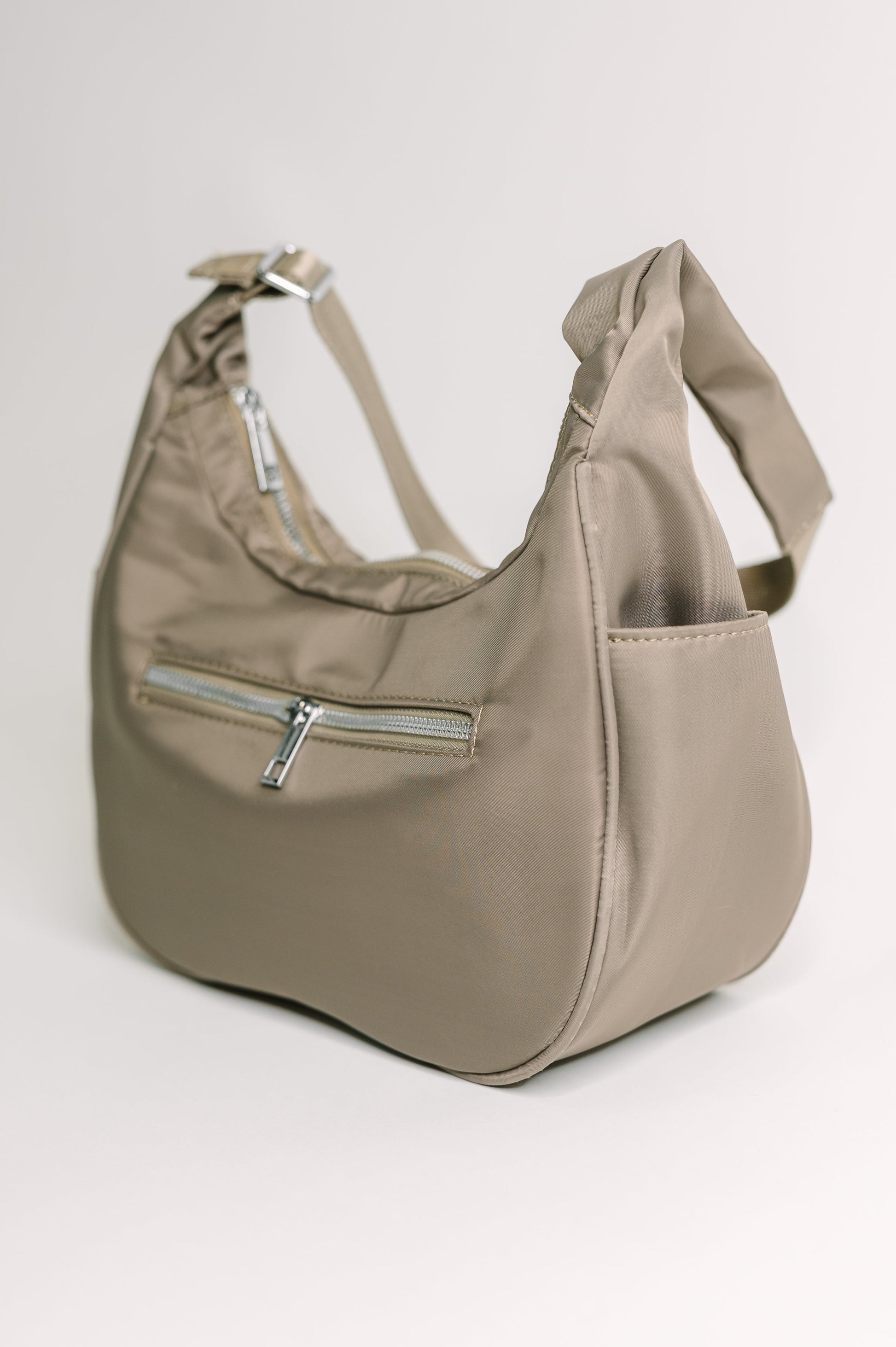 Beige handbag with a zipper on a light gray background