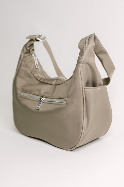 Beige handbag with a zipper on a light gray background