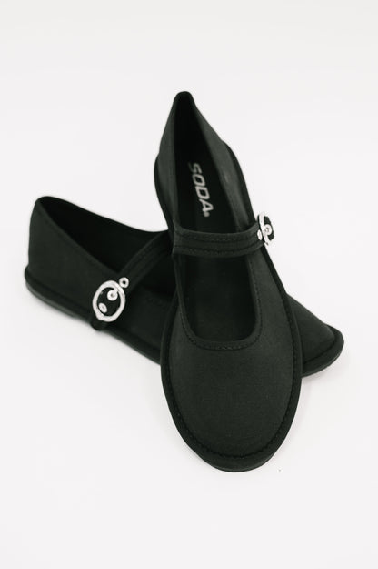 Black shoes with decorative elements on a white background