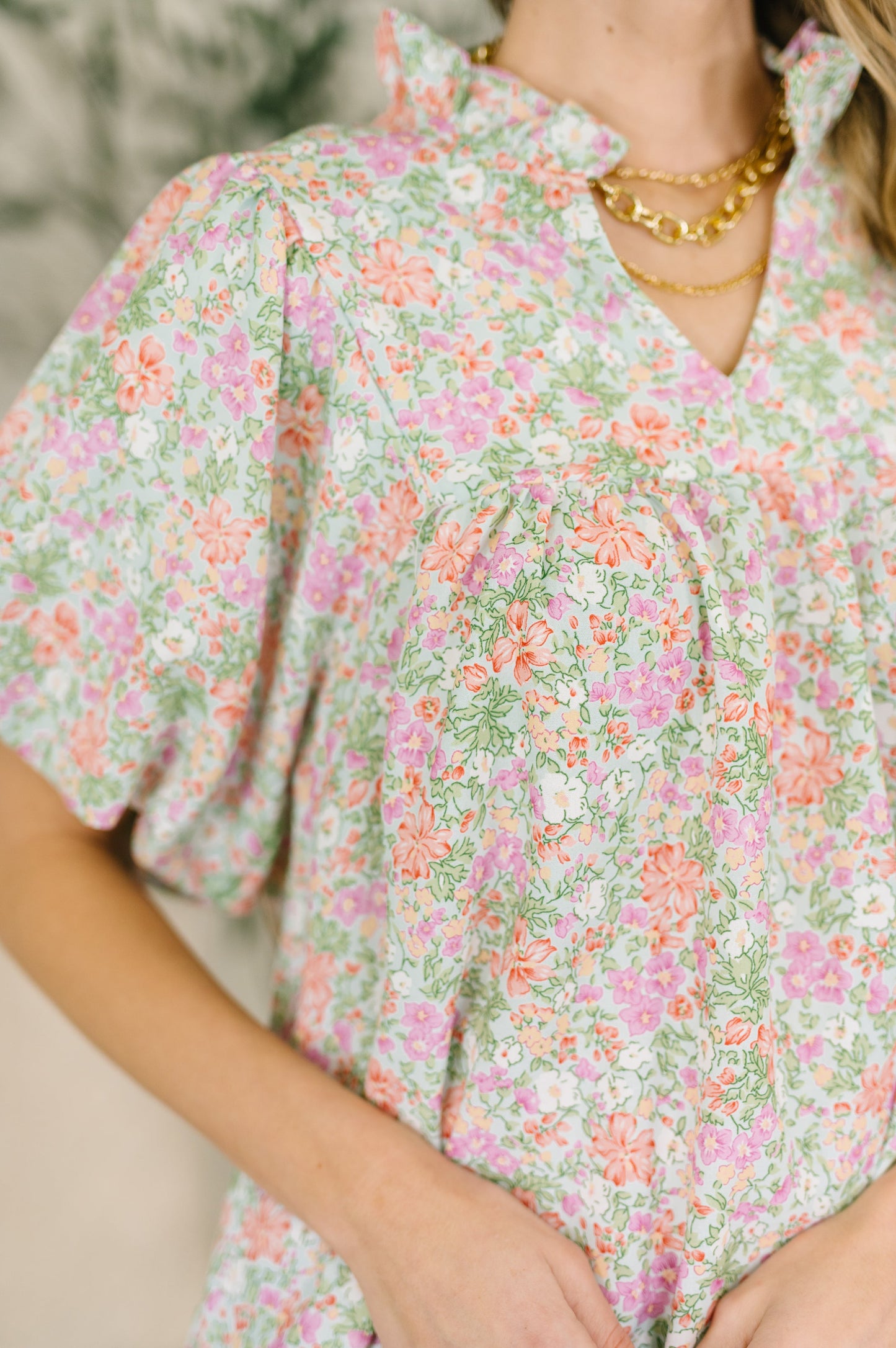 Person wearing a floral dress with a blurred background