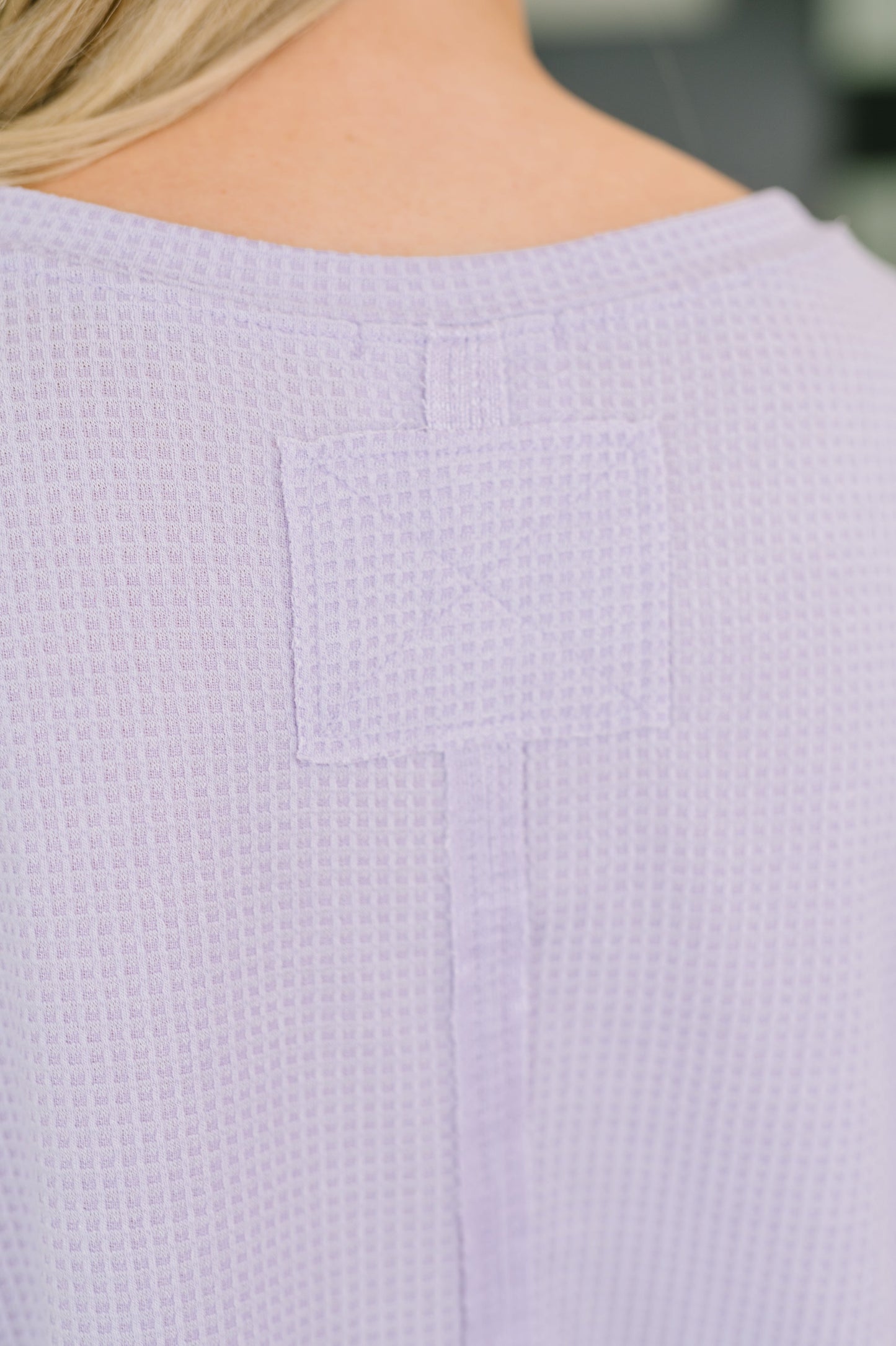 Close-up of a textured lavender garment with a blurred background