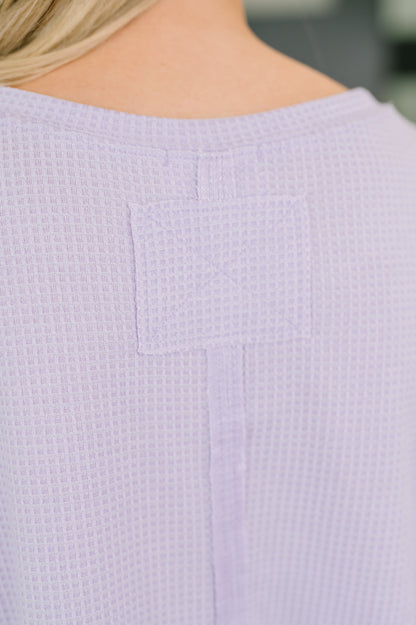 Close-up of a textured lavender garment with a blurred background