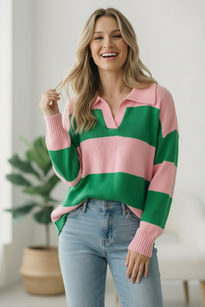 Woman wearing a green and pink striped sweater with a white background