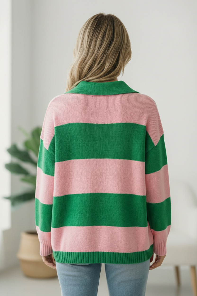 Person wearing a pink and green striped sweater in a room with a plant and light-colored walls.
