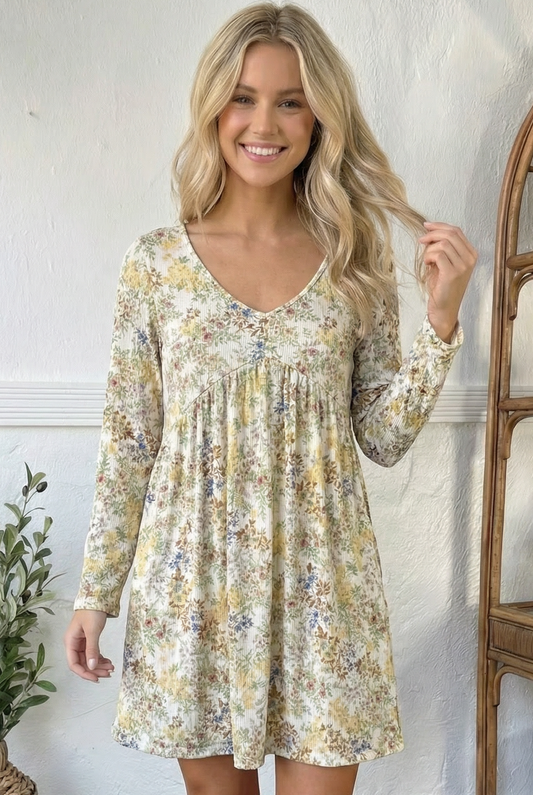 Woman wearing a floral dress against a white wall